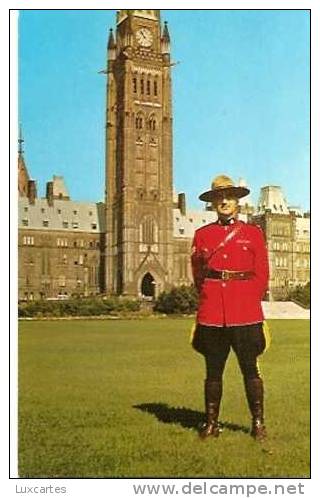A MEMBER OF THE ROYAL CANADIAN MOUNTED POLICE.ONE OF CANADA'S PARLIAMENT BUILDING IN THE BACKGROUND. - Ottawa