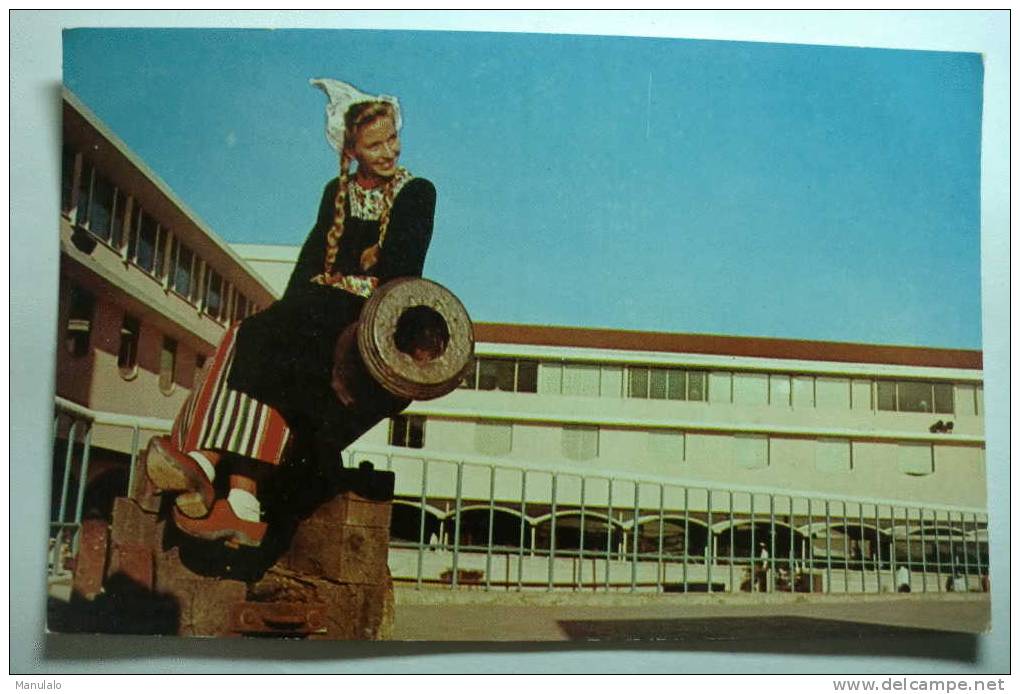 Curacao - Lovely Dutch Girl In Typical Costume Posing On Old Cannon On The Walls Of Historic Waterfort, - Curaçao