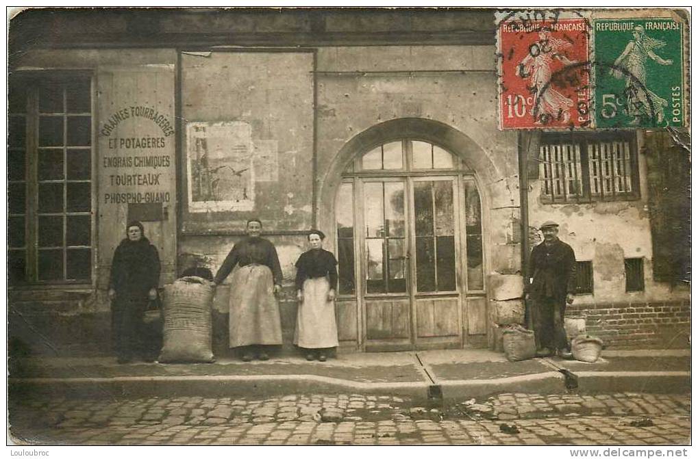 28 CONCHES EN OUCHE CARTE PHOTO RUE SAINTE FOY MAGASIN DE GRAINES FOURRAGERES ET POTAGERES 1920 - Conches-en-Ouche