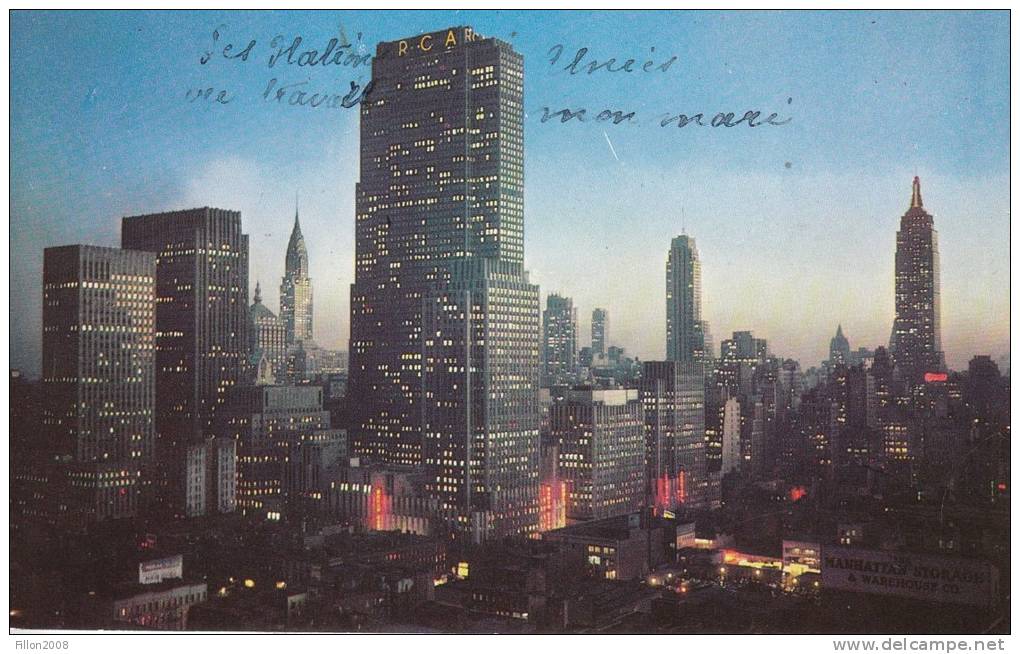 Night Falls On Midtown Manhattan Showing RCA Building Chrysle Building And Empire State Building - Manhattan