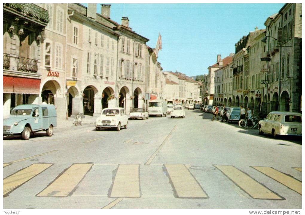 CPM REMIREMONT  Un Coin De La Ville  Avec La Grande Rue  Et Ses Commerces - Remiremont