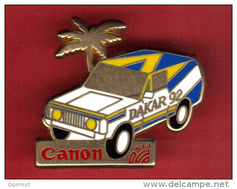 29245-Pin´s .Dakar.Canon.Photo..4X4.t Out Terrain.Rallye.signé Jordenen Et Numéroté 863. - Rally