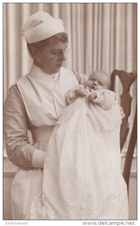 NANNY IN UNIFORM WEARING PINZ NEZ GLASSES WITH BABY. LONG GOWN. - Other & Unclassified
