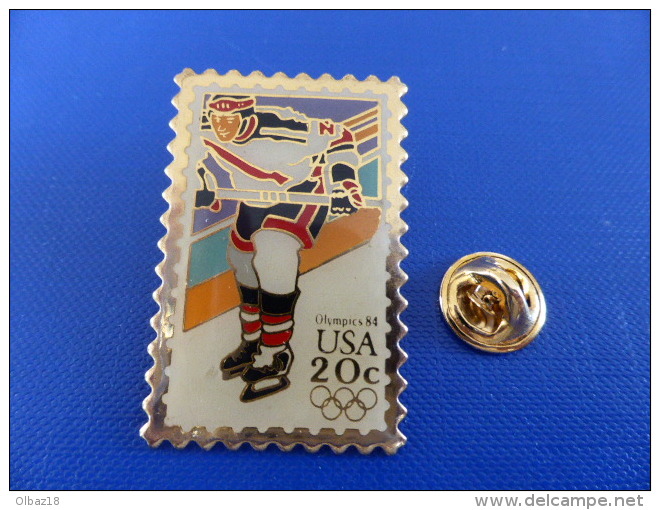 Pin´s Hockey Sur Glace - Jeux Olympiques Los Angeles 1984 - Olympics 84 USA Timbre 20c - Anneaux (PD59) - Sports D'hiver