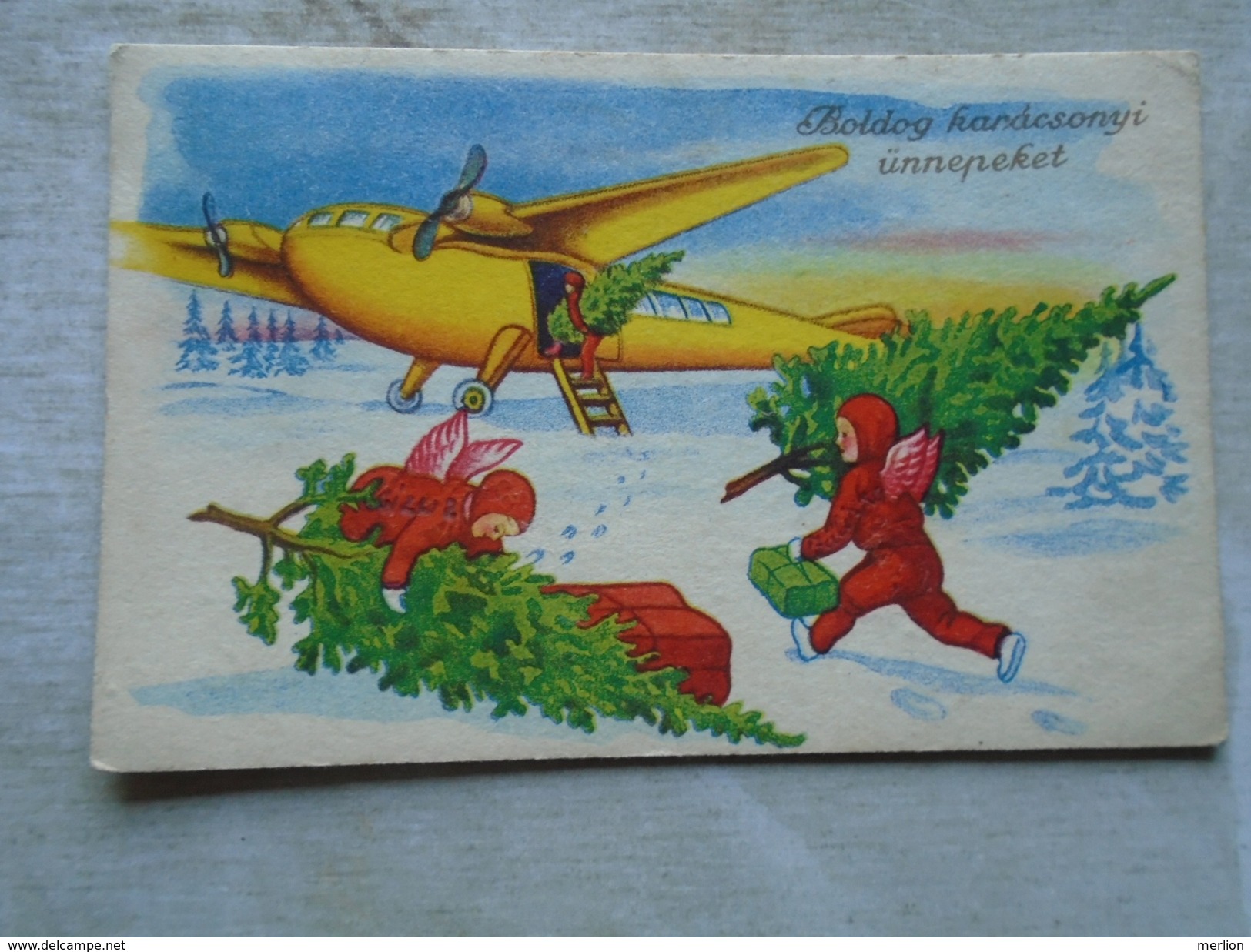 D144608  Hungary Christmas Postcard - Red Robe Angels Carrying  Christmas Tree  With Airplane Angel/Krampus Combination? - Autres & Non Classés