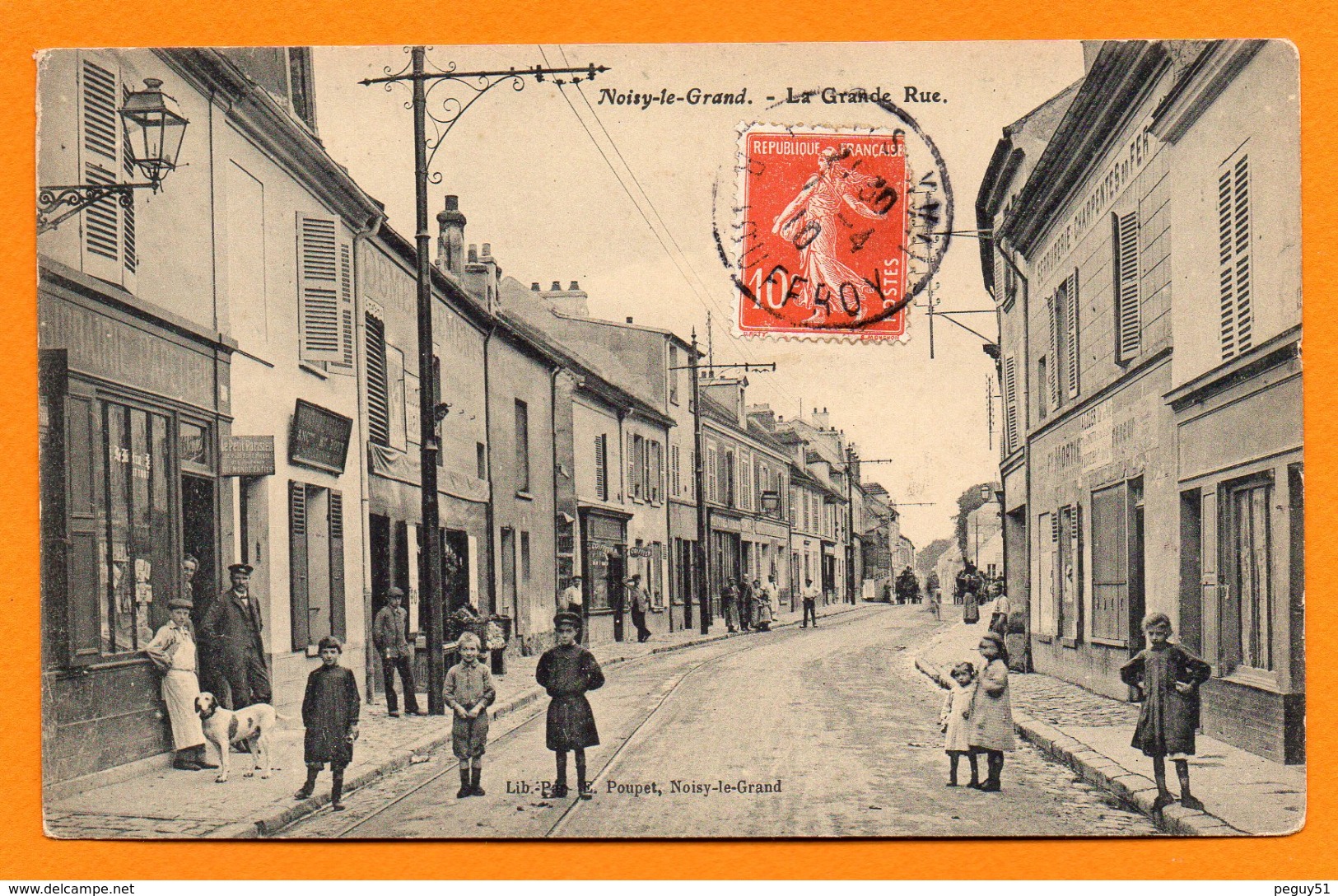 93. Noisy-le-Grand. La Grande Rue. Librairie -Papeterie E. Poupet ,éditeur De Cartes Postales.  1910 - Noisy Le Grand