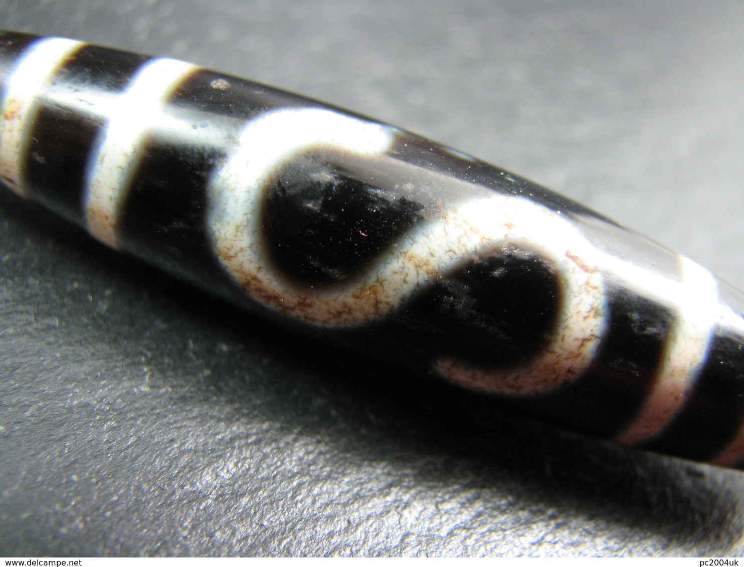 FREE SHIPPING. An agate Dzi bead with a double money hook pattern from Tibet / Nepal FREE SHIPPING.