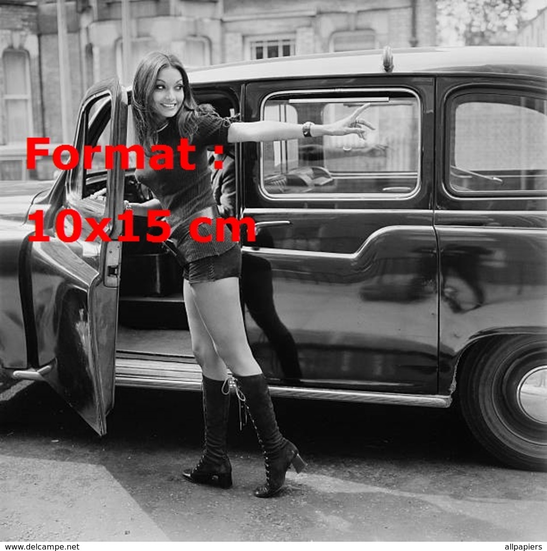 Reproduction D'une Photographie D'une Jeune Femme En Short Court Et Hautes Bottes Noires Entrant Dans Un Taxi Anglais - Sonstige & Ohne Zuordnung