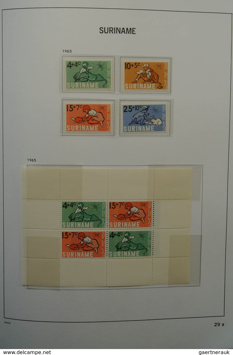 24151 Surinam: 1873-1975. Nicely filled, MNH, mint hinged and used collection Surinam in Davo luxe album.