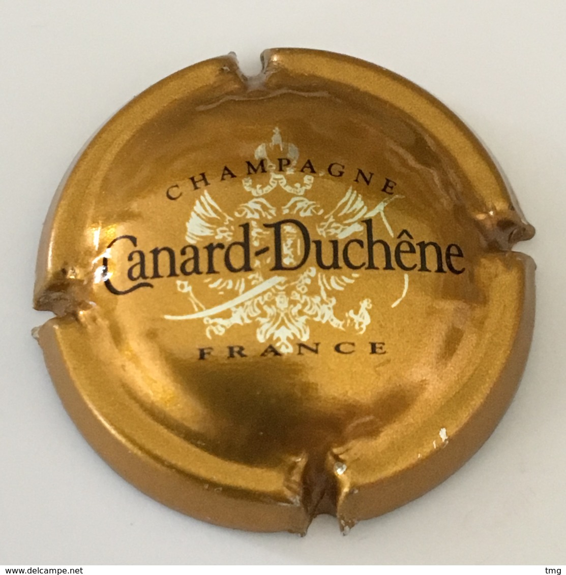 103 - Capsule De Champagne - 75g - Canard-Duchêne, Bronze (petites Lettres) - Canard Duchêne