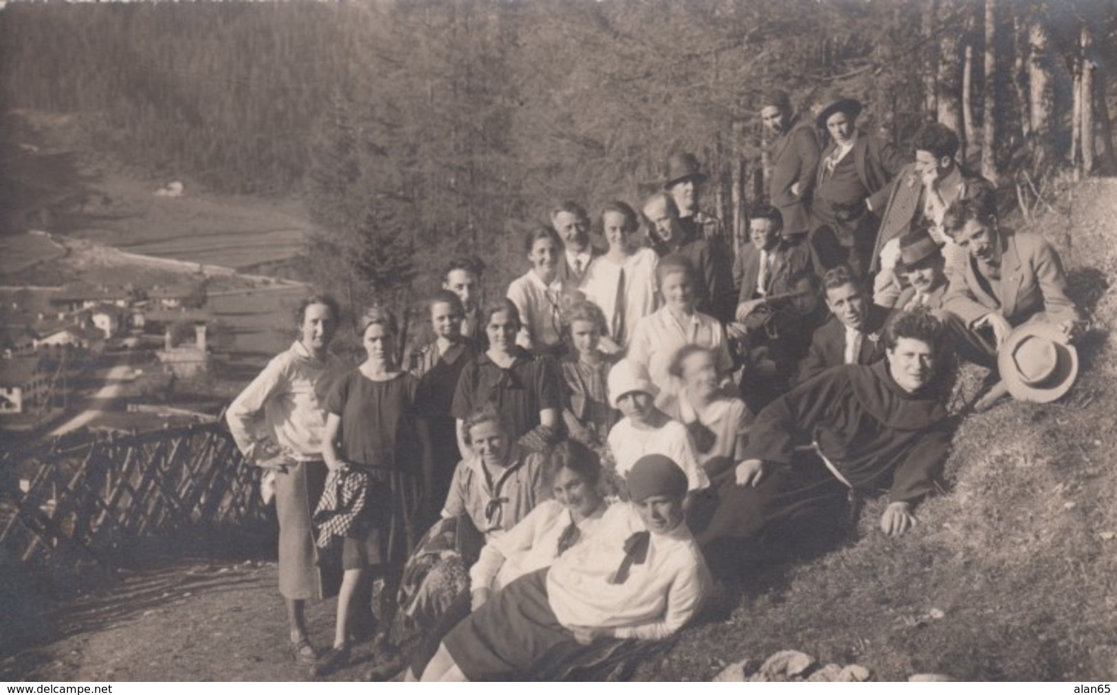 Austria(?), Group Of Men And Women, One Man Dressed As Monk, Pose Above Town, C1920s Vintage Real Photo Postcard - Other & Unclassified