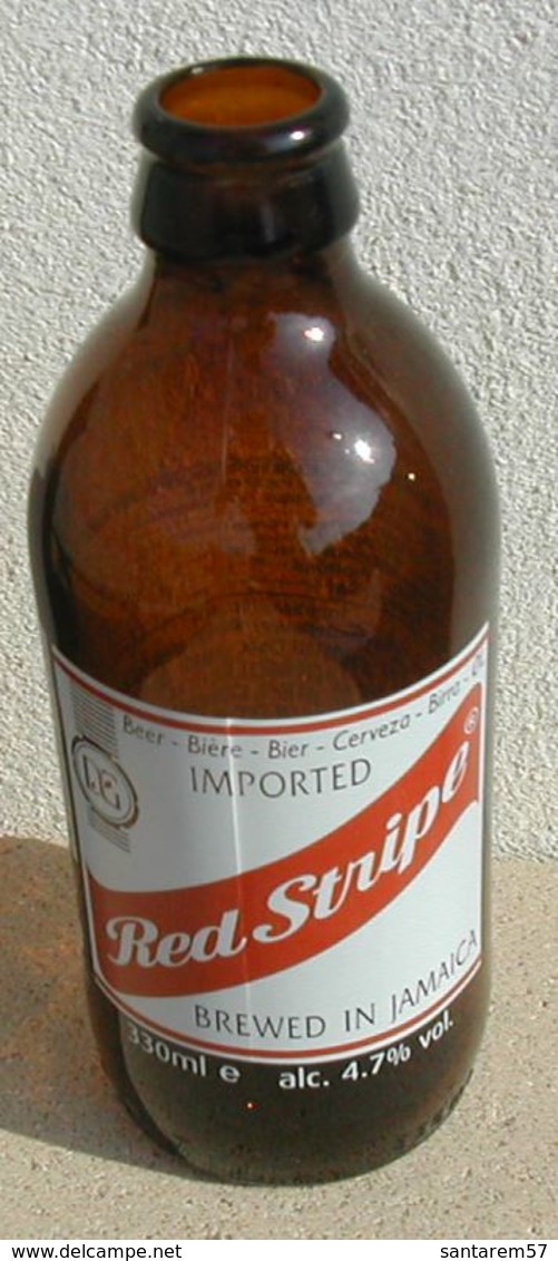 Bouteille Vide Empty Beer Bottle Bière Sérigraphiée Red Stripe Importé Brassée En Jamaique - Bière