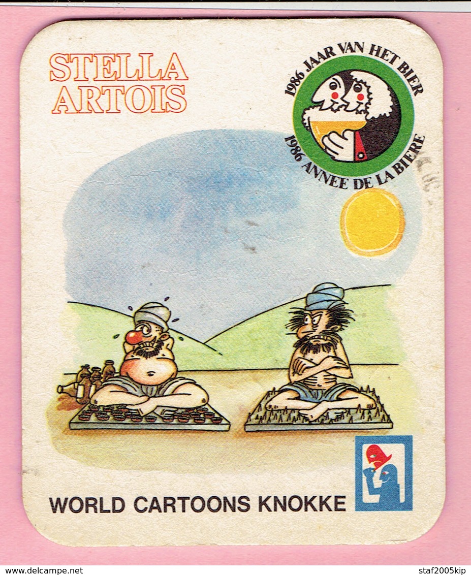 Bierviltjes - STELLA ARTOIS - WORLD CARTOONS KNOKKE - Jaar Van Het Bier 1986 - Bierdeckel