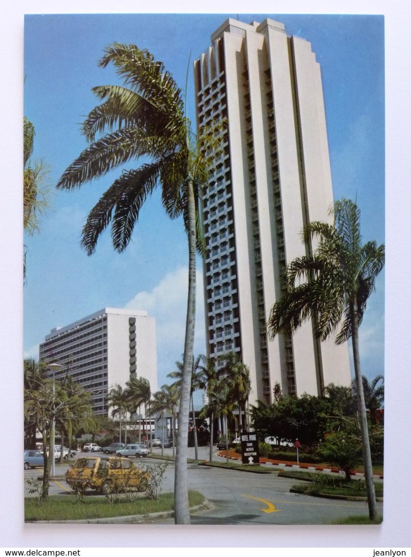 ABIDJAN ( COTE D'IVOIRE / AFRIQUE ) - Hotel IVOIRE , Vue Du Bâtiment Depuis La Rue , Voitures Stationnées Sur Le Parking - Ivory Coast