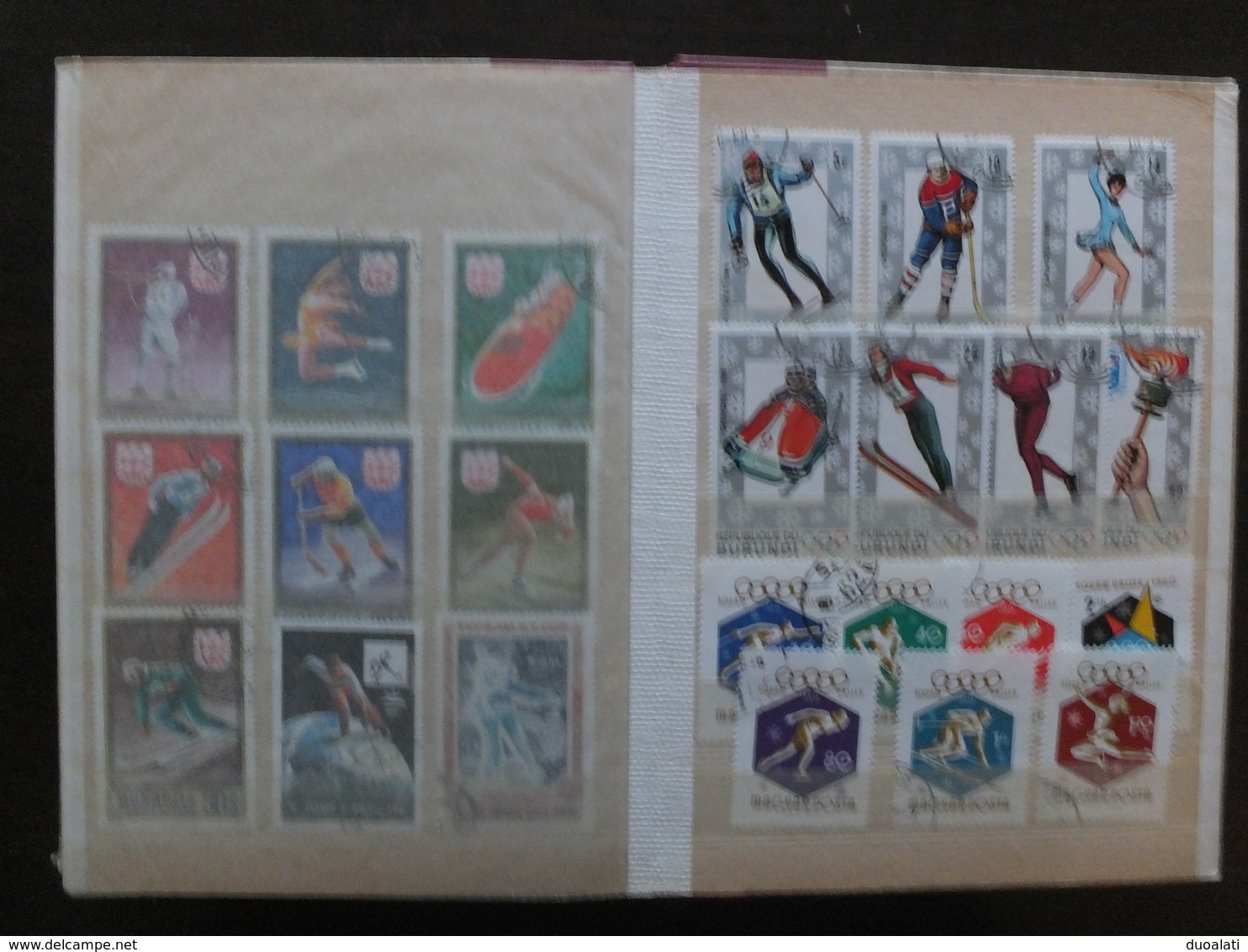 Huge collection of 155 used stamps on topic winter sport with album ski hockey ce skating, bob, speed skating, ski jump