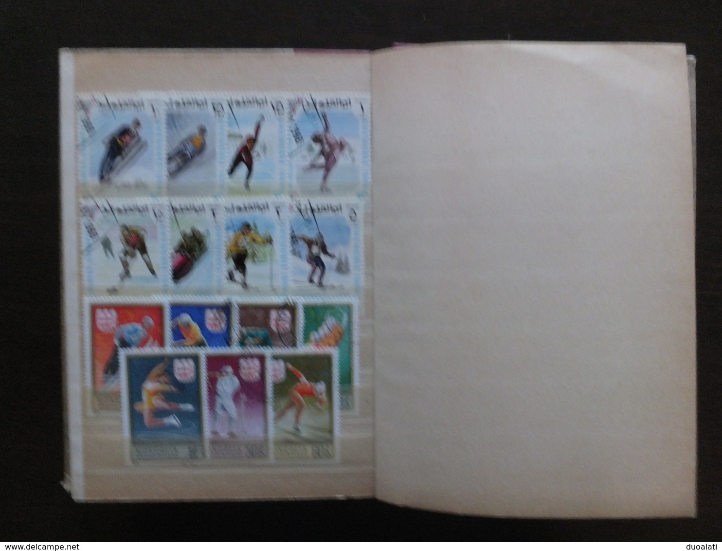 Huge collection of 155 used stamps on topic winter sport with album ski hockey ce skating, bob, speed skating, ski jump