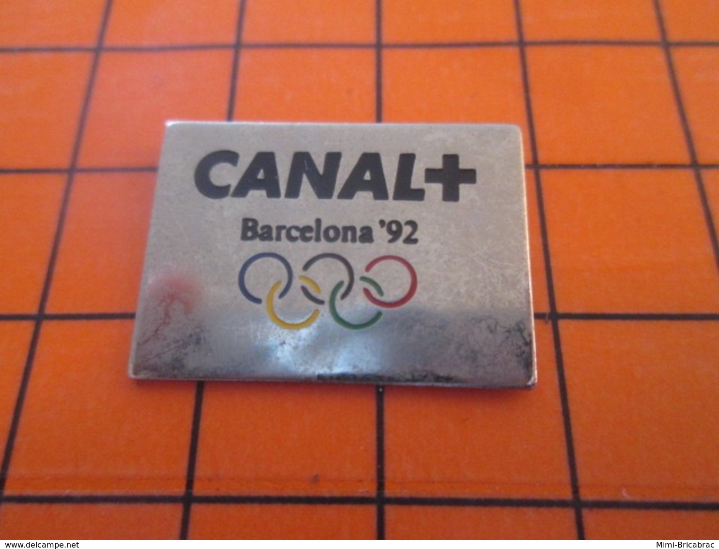 1119 Pin's Pins : BEAU ET RARE : Thème JEUX OLYMPIQUES / ANNEAUX OLYMPIQUES BARCELONA 92 CANAL + - Fotografie