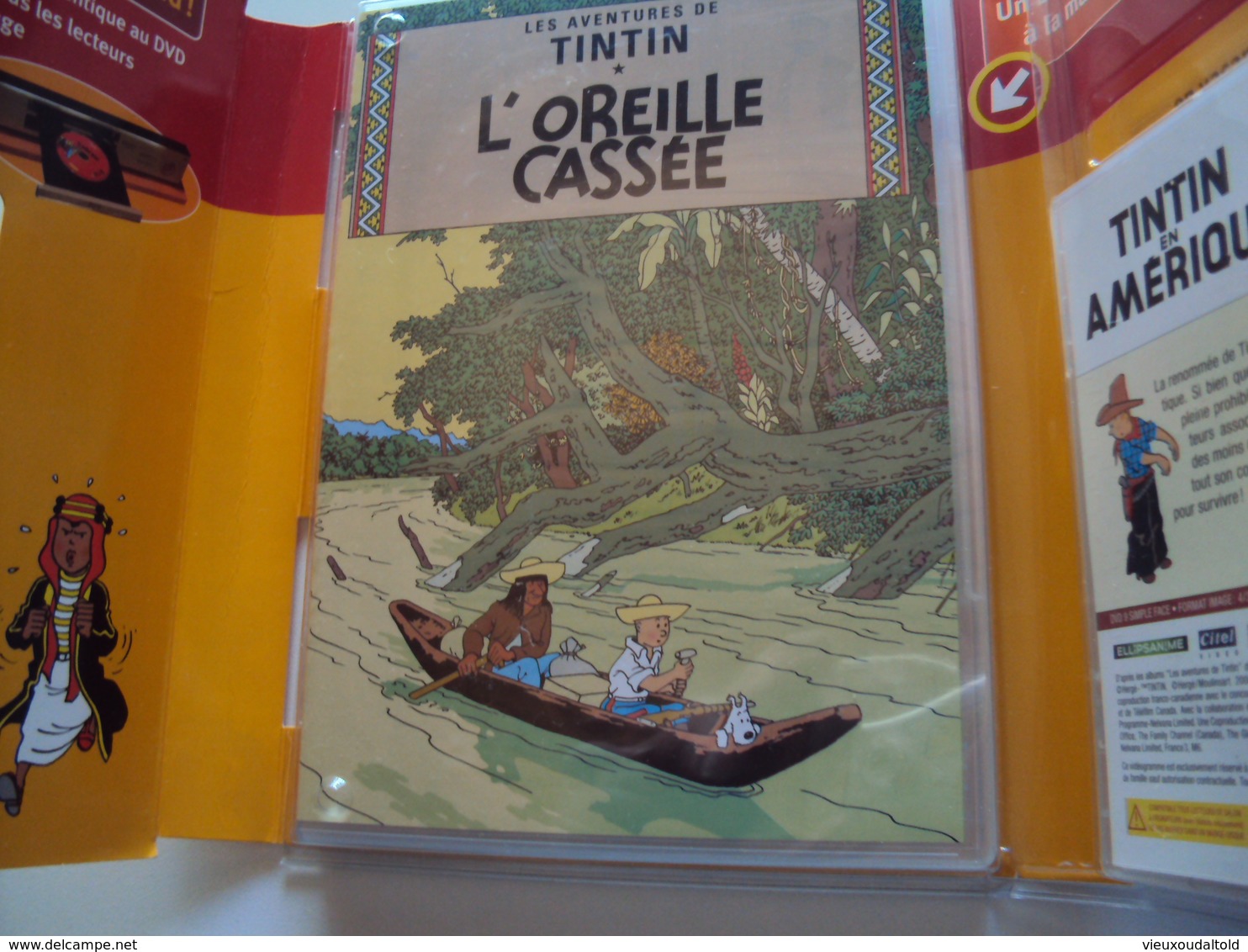 (Neuf Dans Son Emballage) TINTIN  2 AVENTURES INTÉGRALES  TINTIN  En AMÉRIQUE Et L'OREILLE CASSÉE - Cartoons