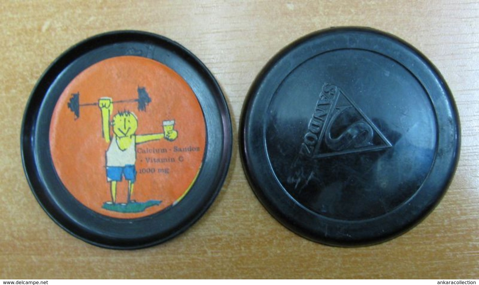 AC -  CALCIUM SANDOZ VINTAGE SAUCER TYPE PLASTIC COASTER - WEIGHTLIFTER - Ancient Tools