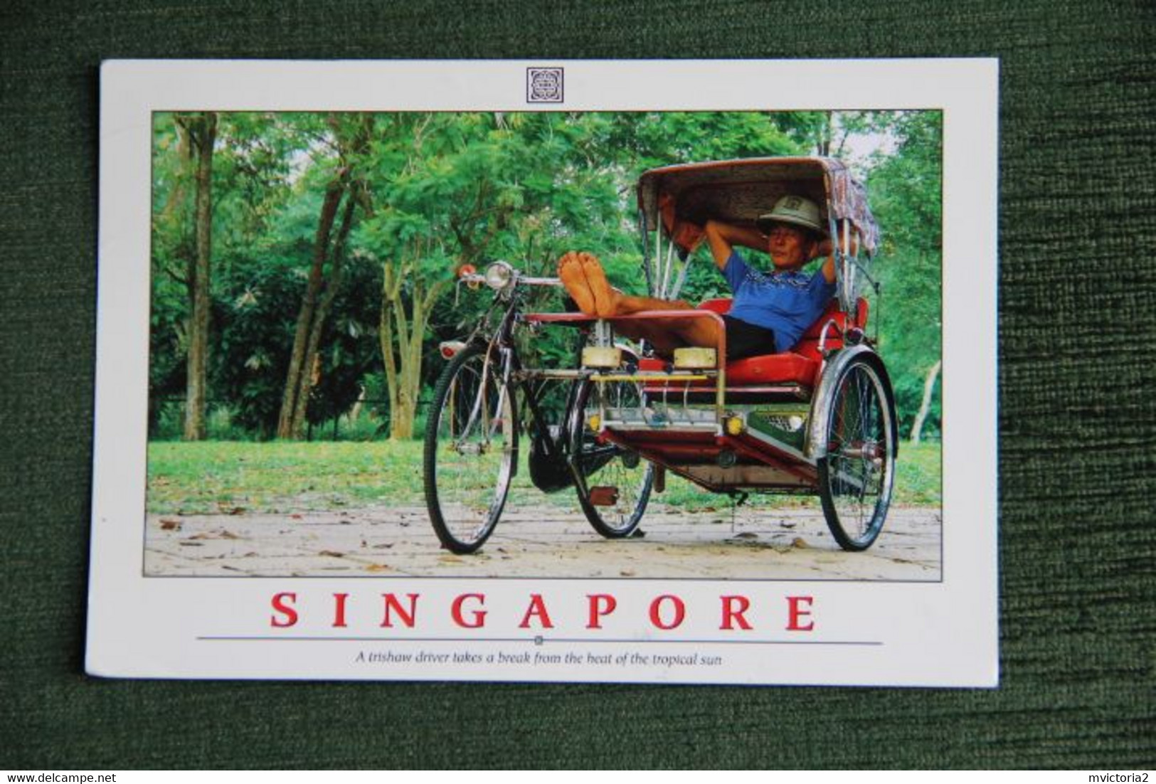 SINGAPORE - A Trishaw Driver Takes A Break From The Heat Of The Tropical Sun. - Singapore