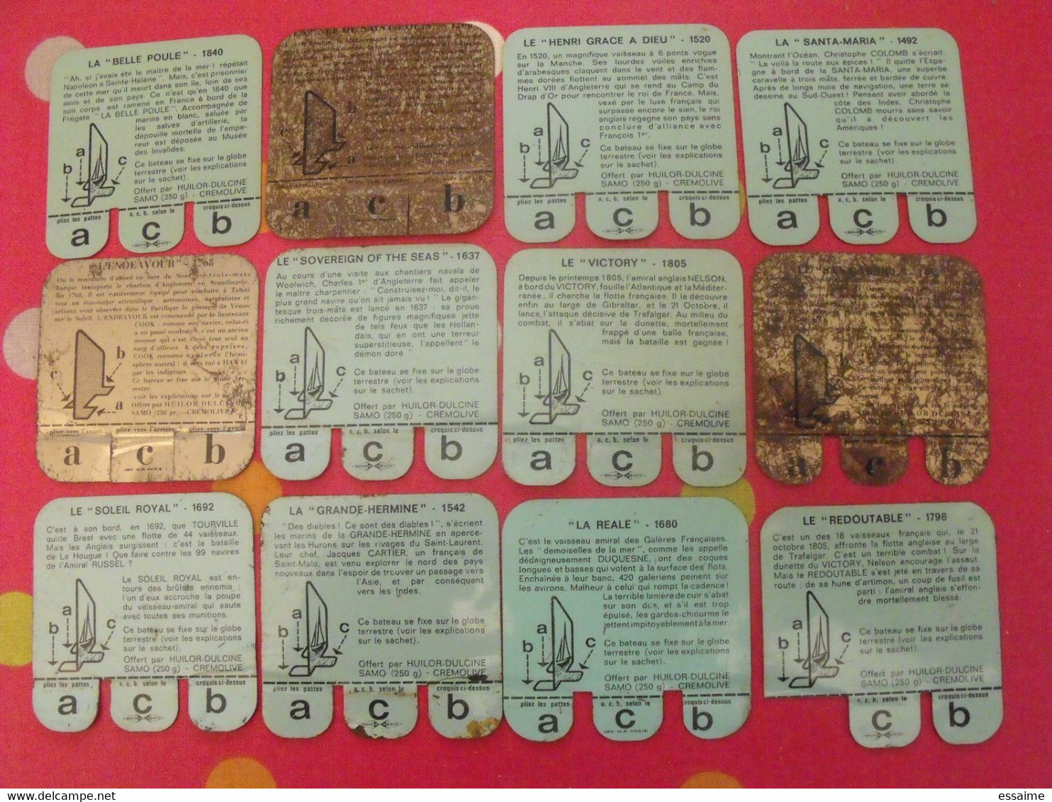 Lot De 12 Plaquettes Bateaux. Huilor Samo Chat Ambré Cremolive. Lot 9 - Plaques En Tôle (après 1960)