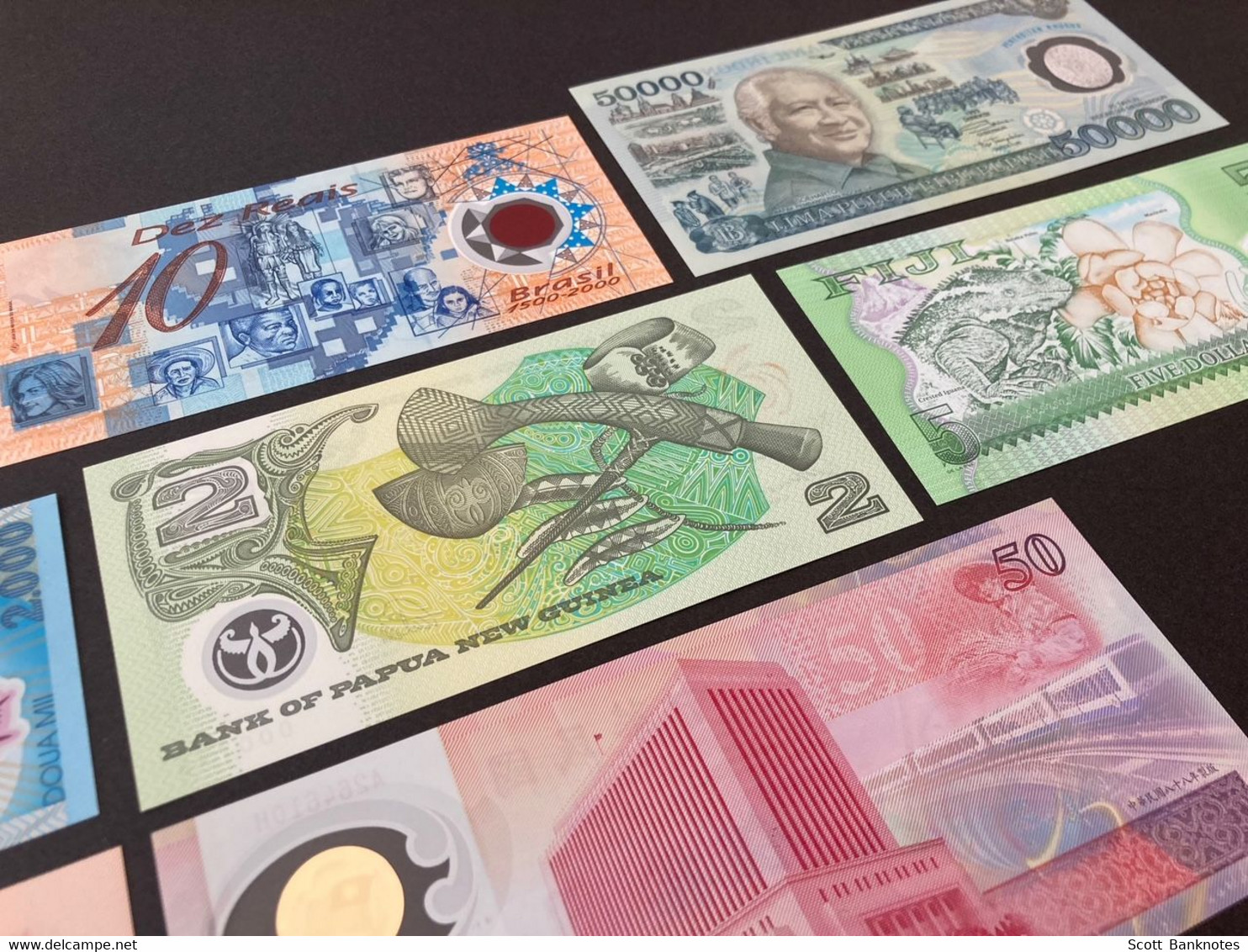 8 X Uncirculated Polymer Banknotes, inc. China, Fiji, New Guinea, Indonesia and more.