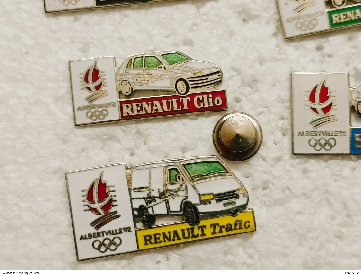 Pin's Jeux Olympiques ALBERTVILLE avec les Véhicules de Transport RENAULT - Lot de 7 Pins EGF COJO 1991