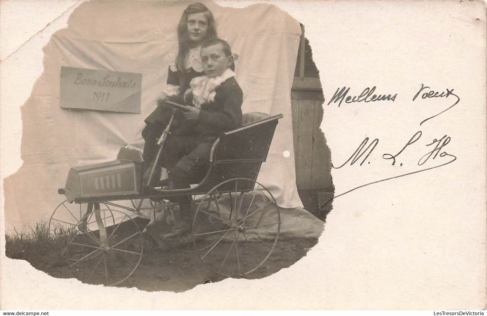 CPA Photo D'un Petit Garçon Dans Une Petite Voiture A Pedale Avec Sa Soeur - Bons Souhaits 1911 - Jouet - Giochi, Giocattoli