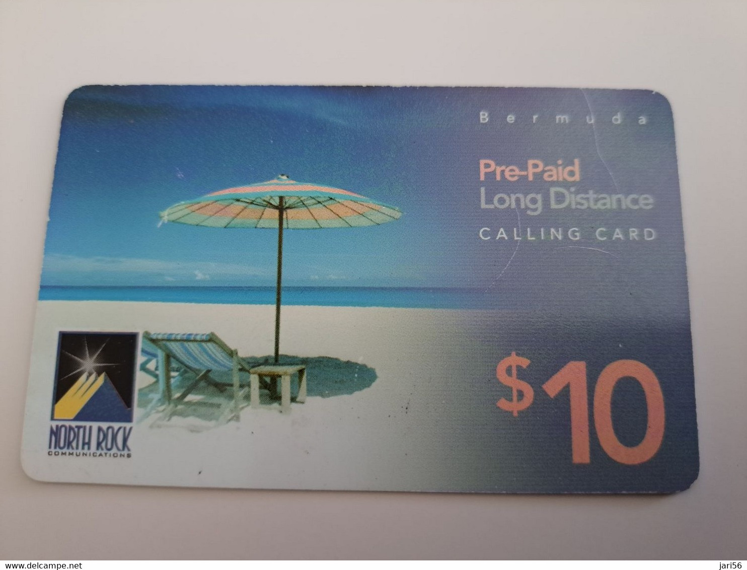 BERMUDA  $10,-,-NORTH ROCK   BERMUDA / PARASOL ON BEACH /  DIFFERENT BACK/   PREPAID CARD  Fine USED  **11271** - Bermudes