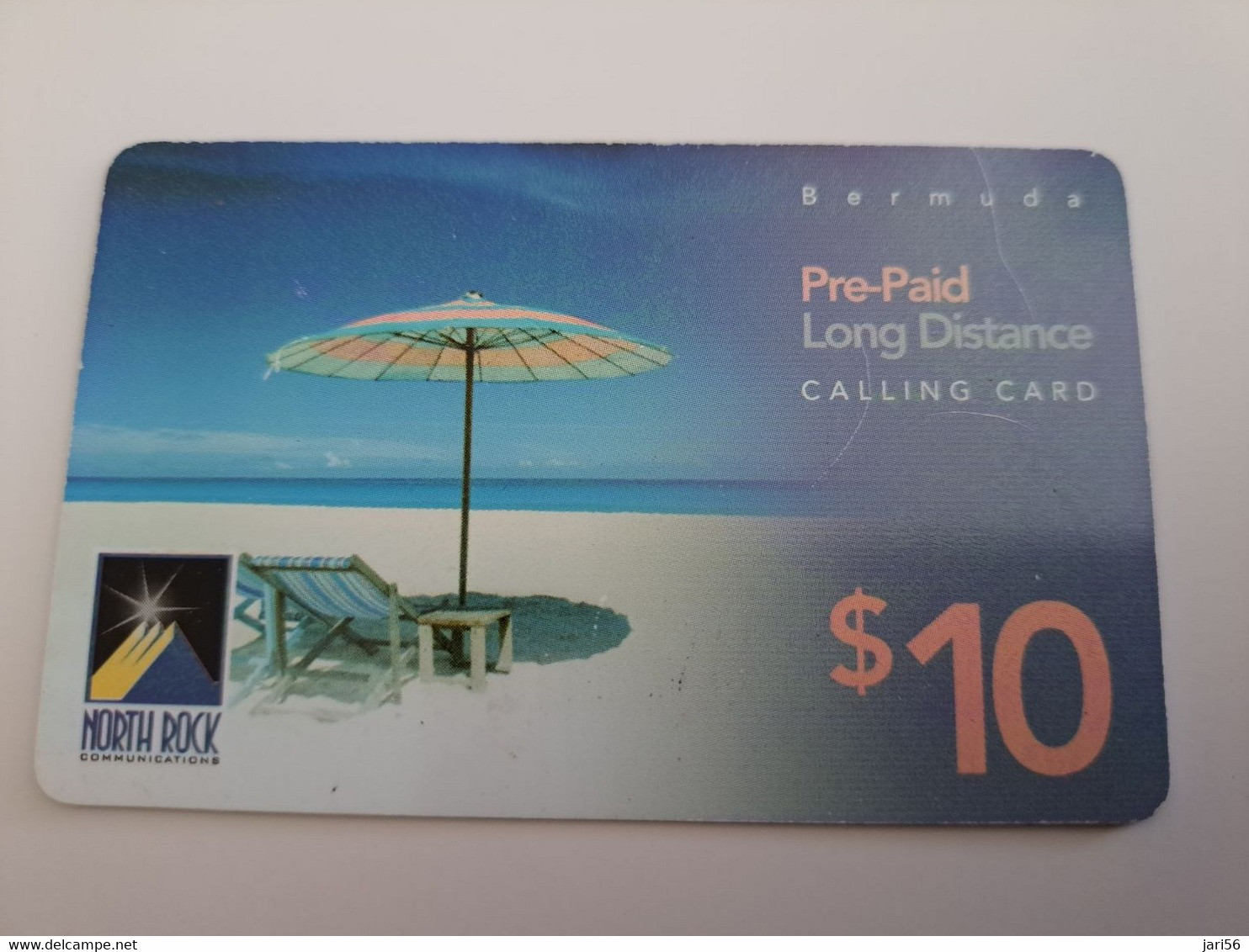 BERMUDA  $10,-,-NORTH ROCK   BERMUDA / PARASOL ON BEACH /  DIFFERENT BACK/   PREPAID CARD  Fine USED  **11271** - Bermudas