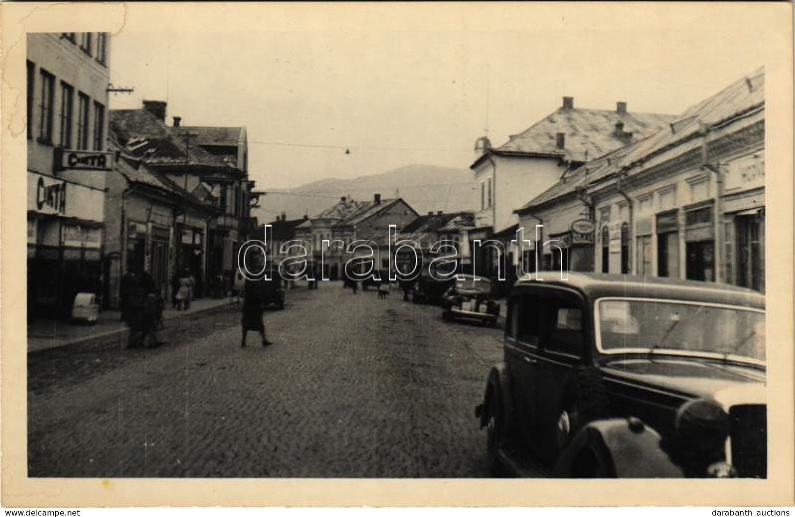 * T2/T3 Huszt, Chust, Khust; Fő Utca, Cikta, üzletek, Automobilok / Main Street, Shops, Automobiles. Photo (fl) - Ohne Zuordnung