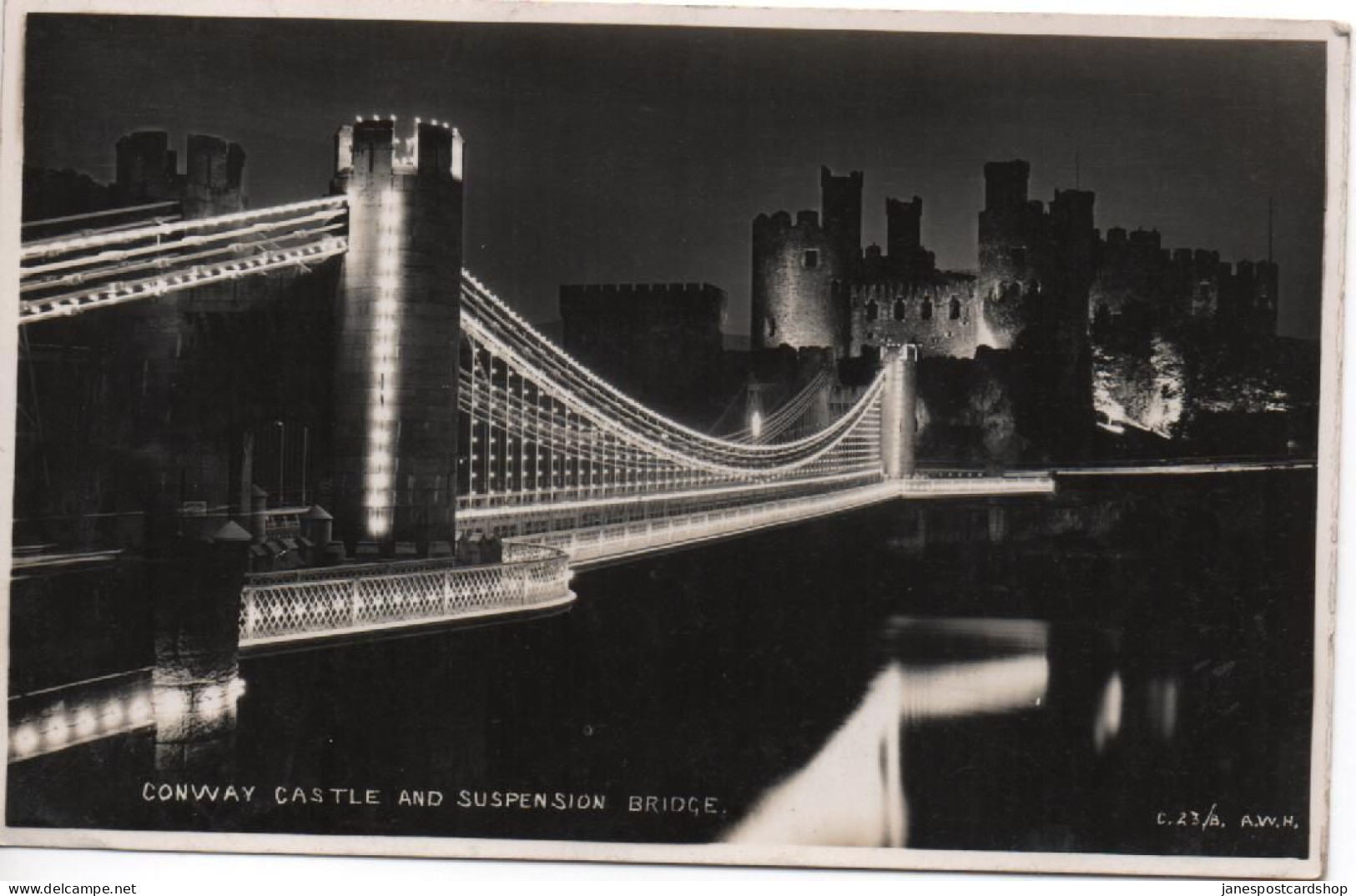 REAL PHOTOGRAPHIC POSTCARD - CONWAY CASTLE AND SUSPENSION BRIDGE AT NIGHT WITH GOOD LLANDUDNO JUNCTION POSTMARK - Caernarvonshire