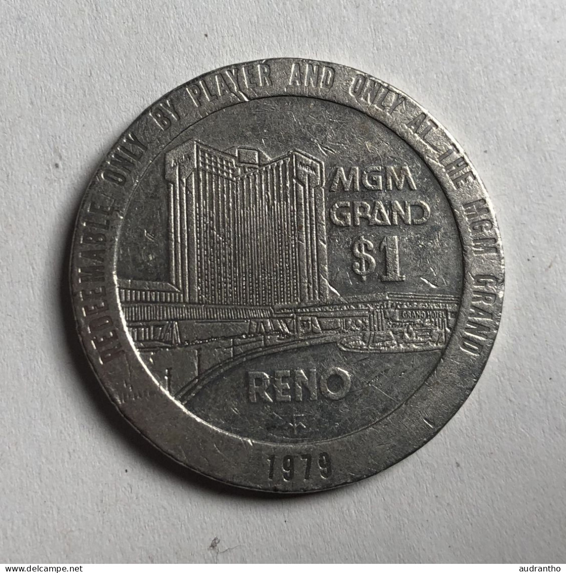 Jeton Etats-Unis - 1 Dollar Gaming Token - MGM Grand Casino RENO 1979 - Andere & Zonder Classificatie