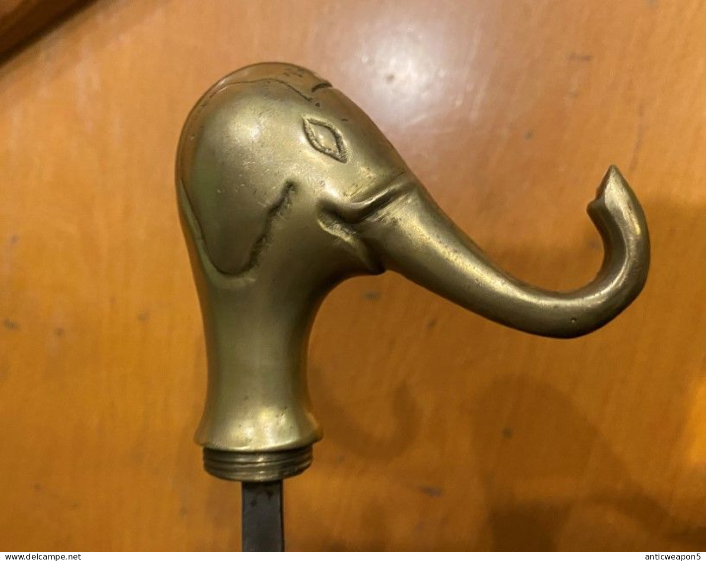 A cane with a pike inside and a heavy brass handle in the shape of an elephant's head. Europe. Around 1940. (H311)