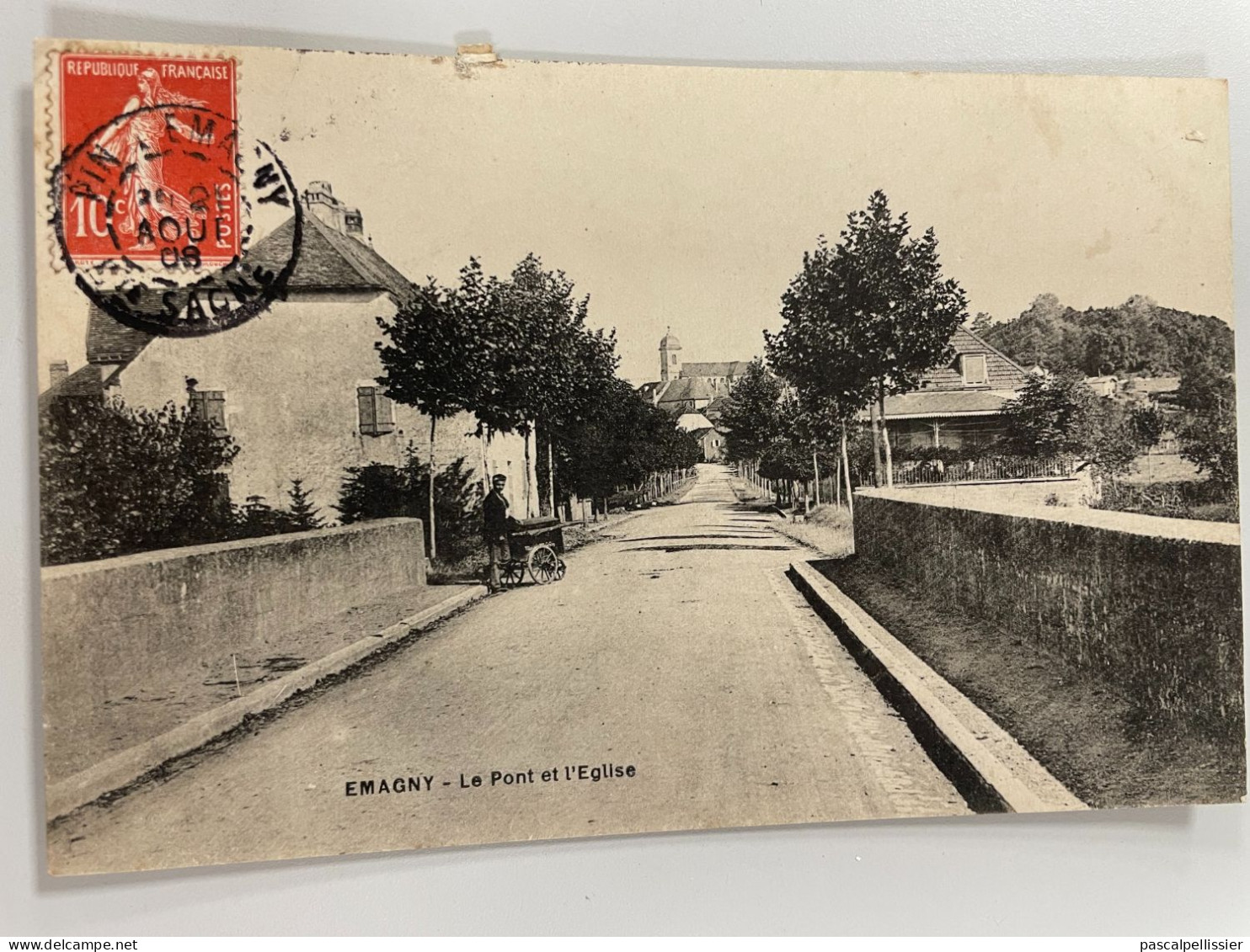 CPA - 70 - EMAGNY - Le Pont Et L' Eglise - Animée Rare Et TBE - Verso Cachet Hôtel Des Voyageurs - Emile BADIN - Montbozon