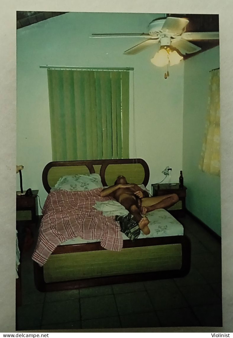 A Naked Man Is Lying On A Bed - Unclassified