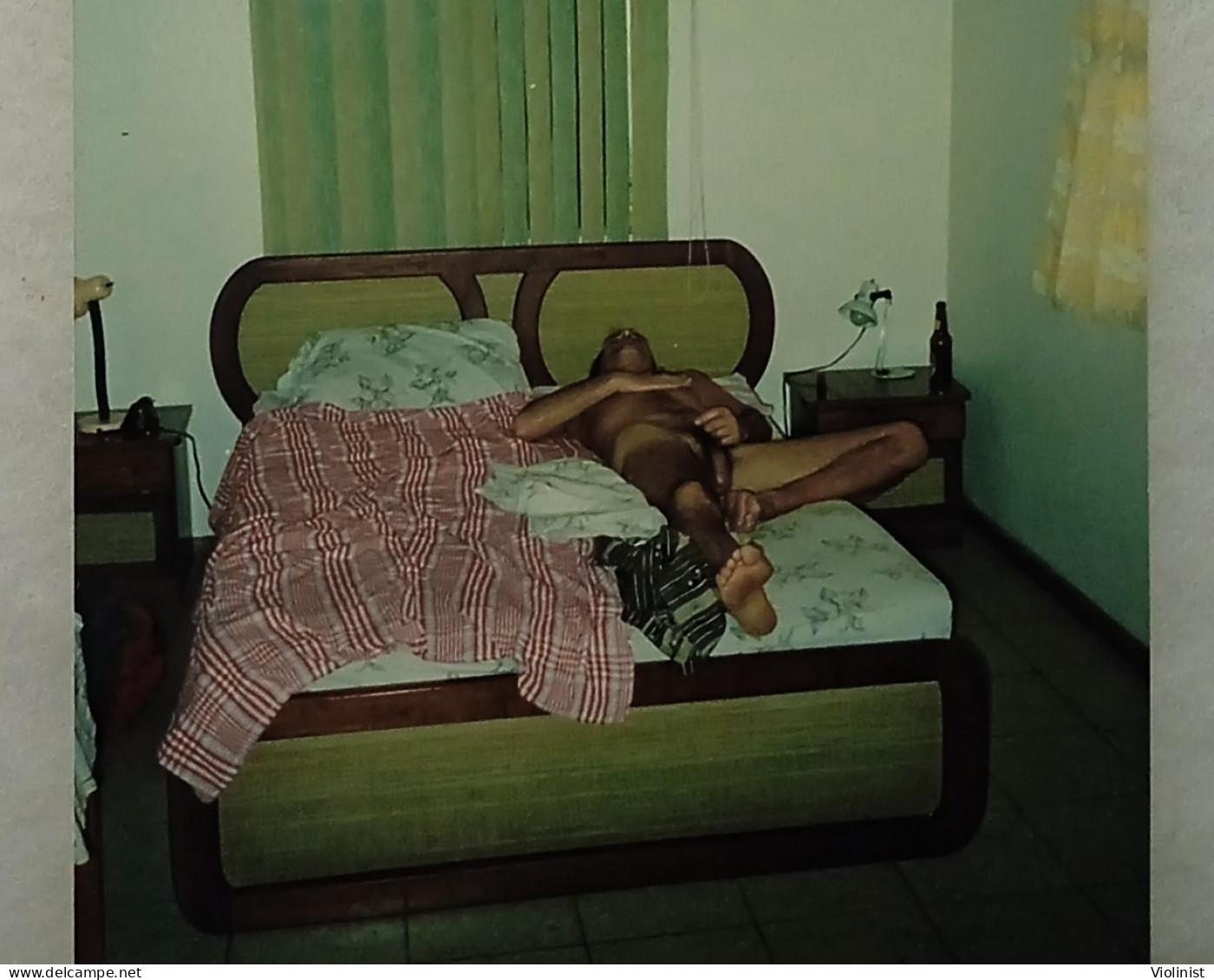 A Naked Man Is Lying On A Bed - Unclassified