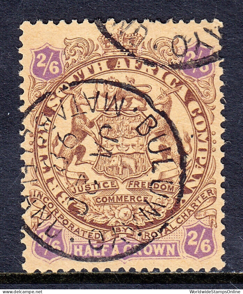 RHODESIA — SCOTT 35 — 1896 2/6- BROWN & VIOLET ON YELLOW ARMS — USED — SCV $65 - Northern Rhodesia (...-1963)