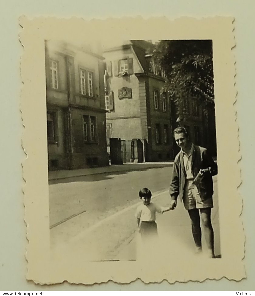 Germany- A Little Girl And A Man Are Walking Down The Street Of The City Of Freiburg Im Breisgau - Places