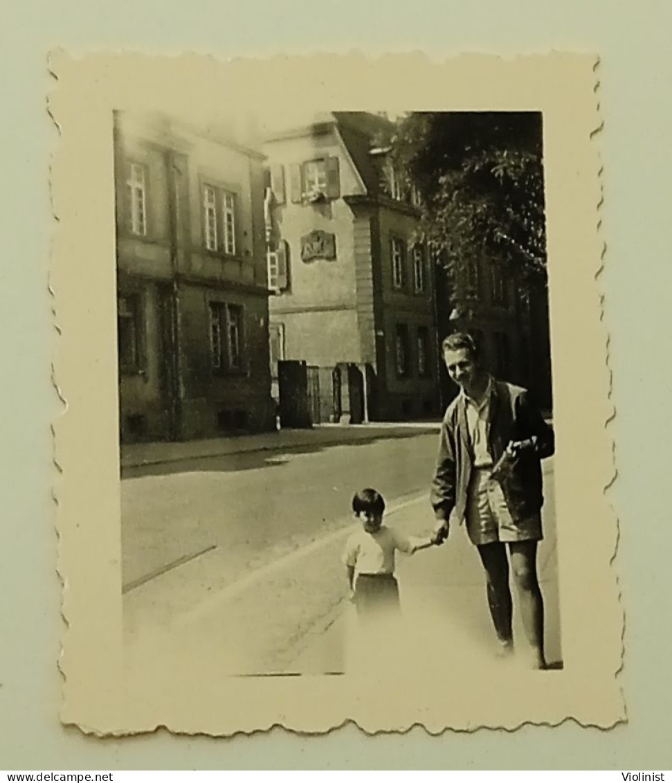 Germany- A Little Girl And A Man Are Walking Down The Street Of The City Of Freiburg Im Breisgau - Places