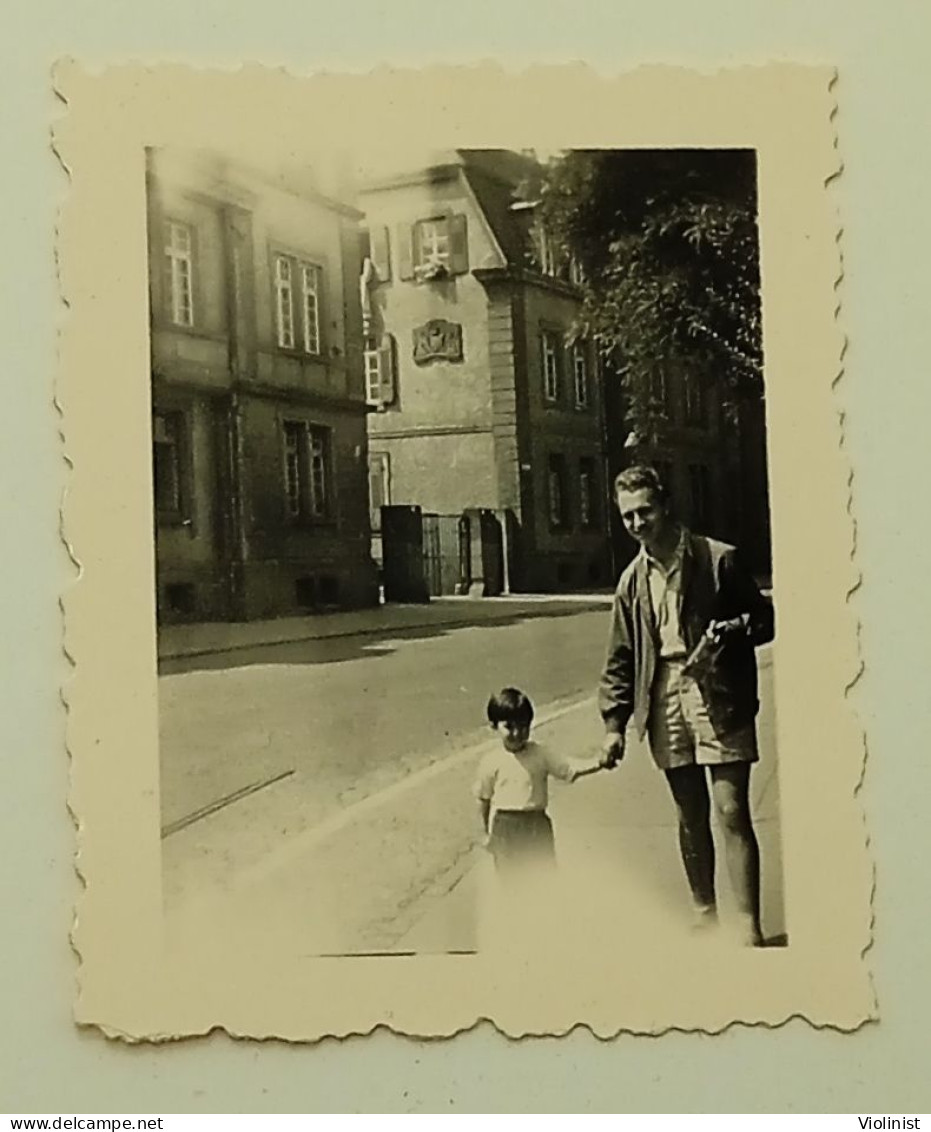 Germany- A Little Girl And A Man Are Walking Down The Street Of The City Of Freiburg Im Breisgau - Places