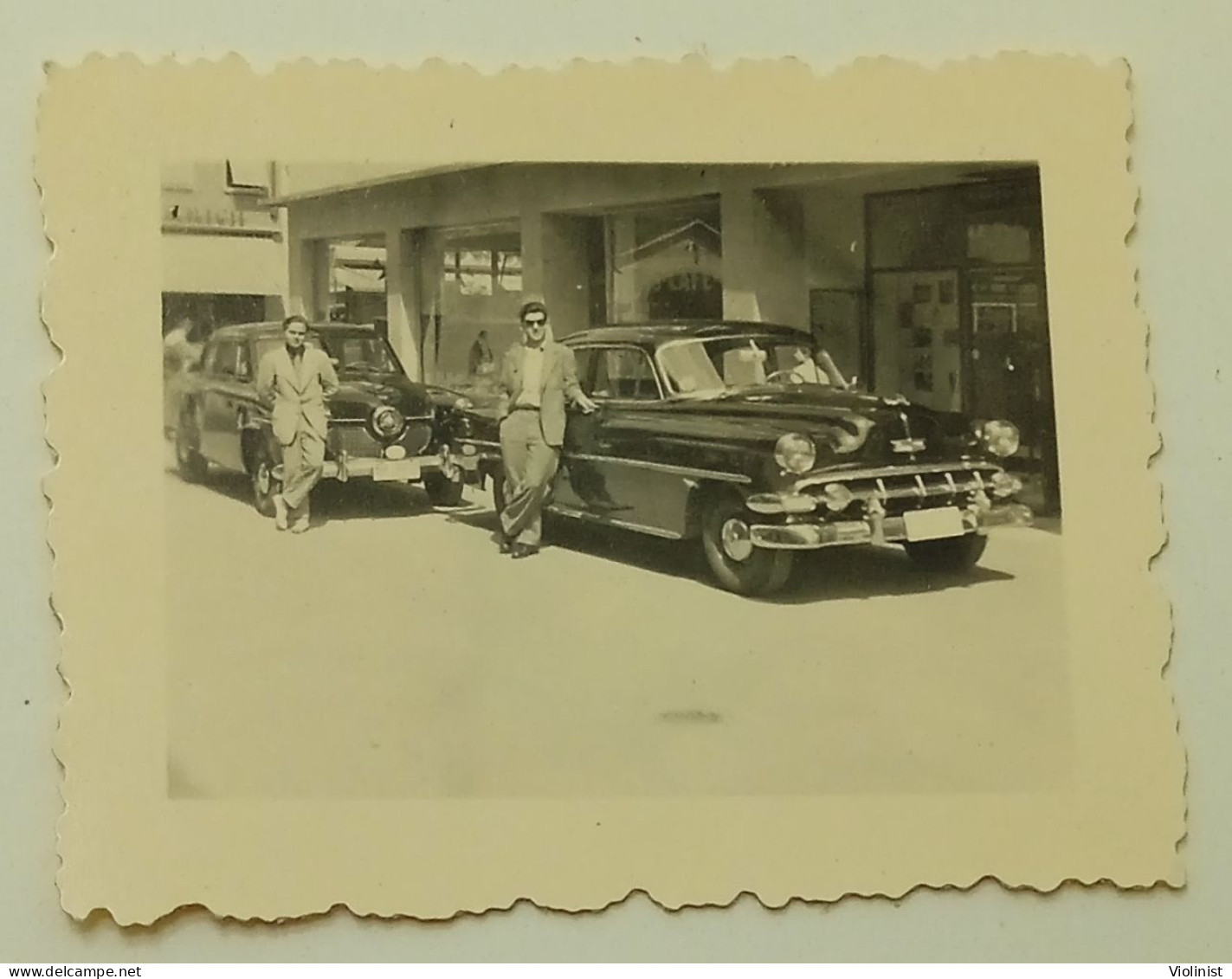 People On The Street At Studebaker Commander And Chevrolet Bel Air Cars - Cars