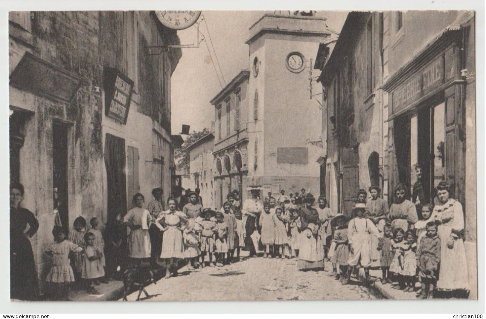 CARTE PHOTO - BOUCHERIE CHARCUTERIE " C. HUGON " - EPICERIE FINE - HORLOGER - RUES TRES ANIMEES D'UN VILLAGE A SITUER - - A Identifier