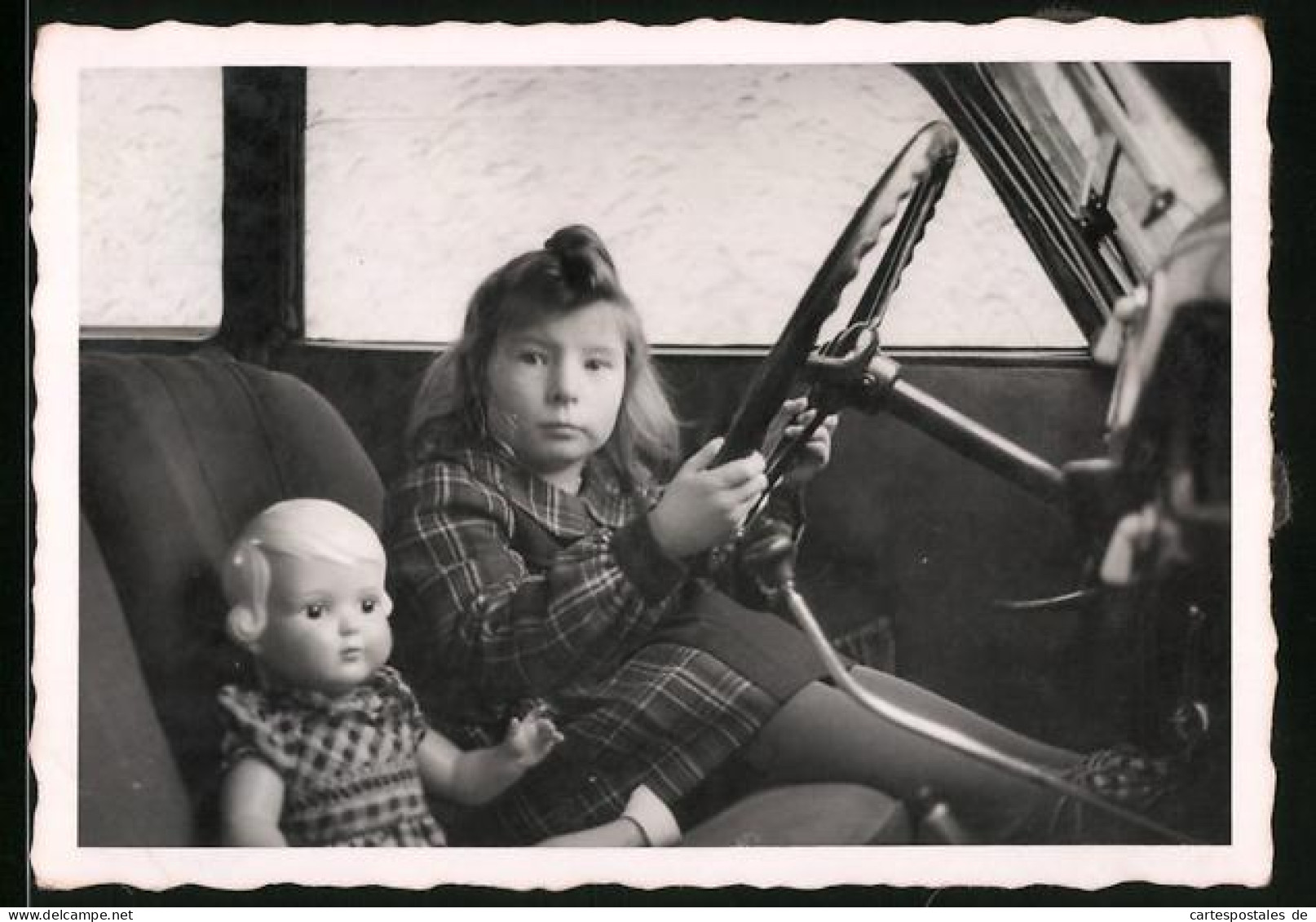 Fotografie Auto, Mädchen Nebst Puppe Am Steuer Sitzend  - Automobile