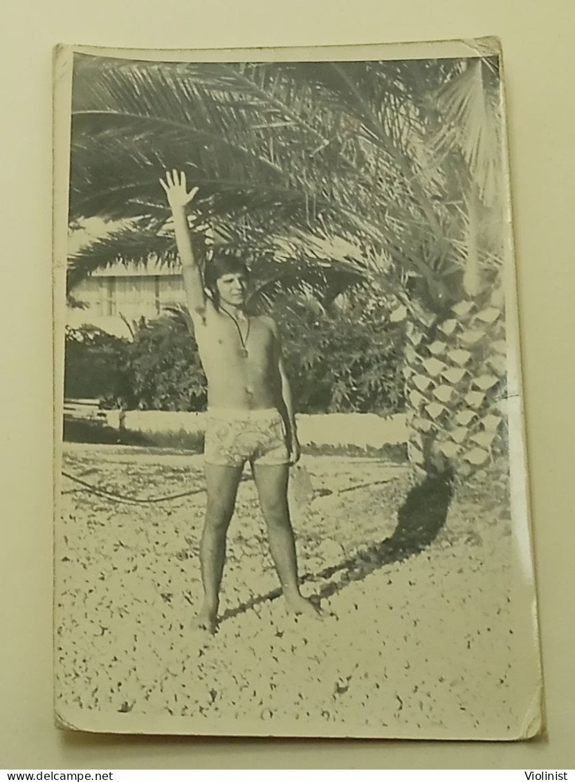 A Guy At Sea Under A Palm Tree - Anonymous Persons