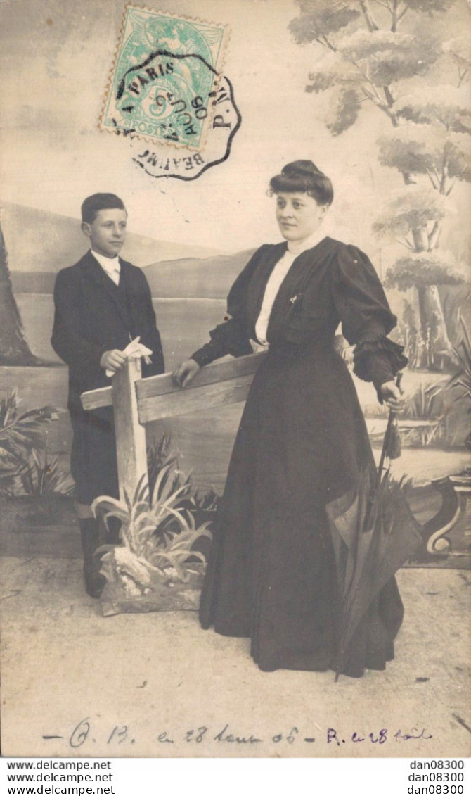 CARTE PHOTO NON IDENTIFIEE REPRESENTANT UNE FEMME ET UN JEUNE GARCON DANS UN STUDIO AVEC DECOR CAMPAGNARD - A Identifier