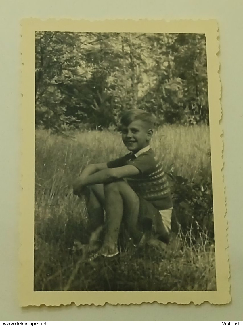 The Boy Is Sitting On The Grass - Anonymous Persons
