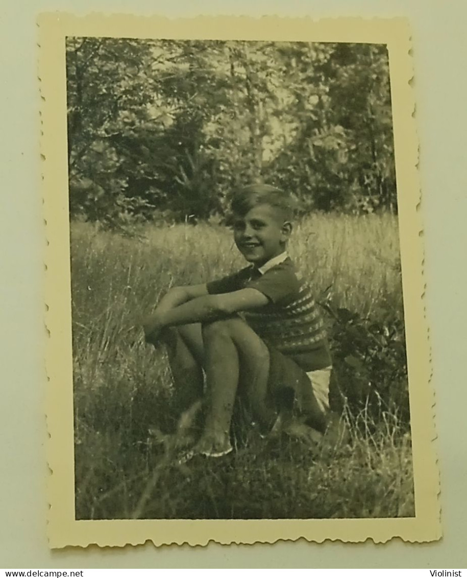 The Boy Is Sitting On The Grass - Anonymous Persons