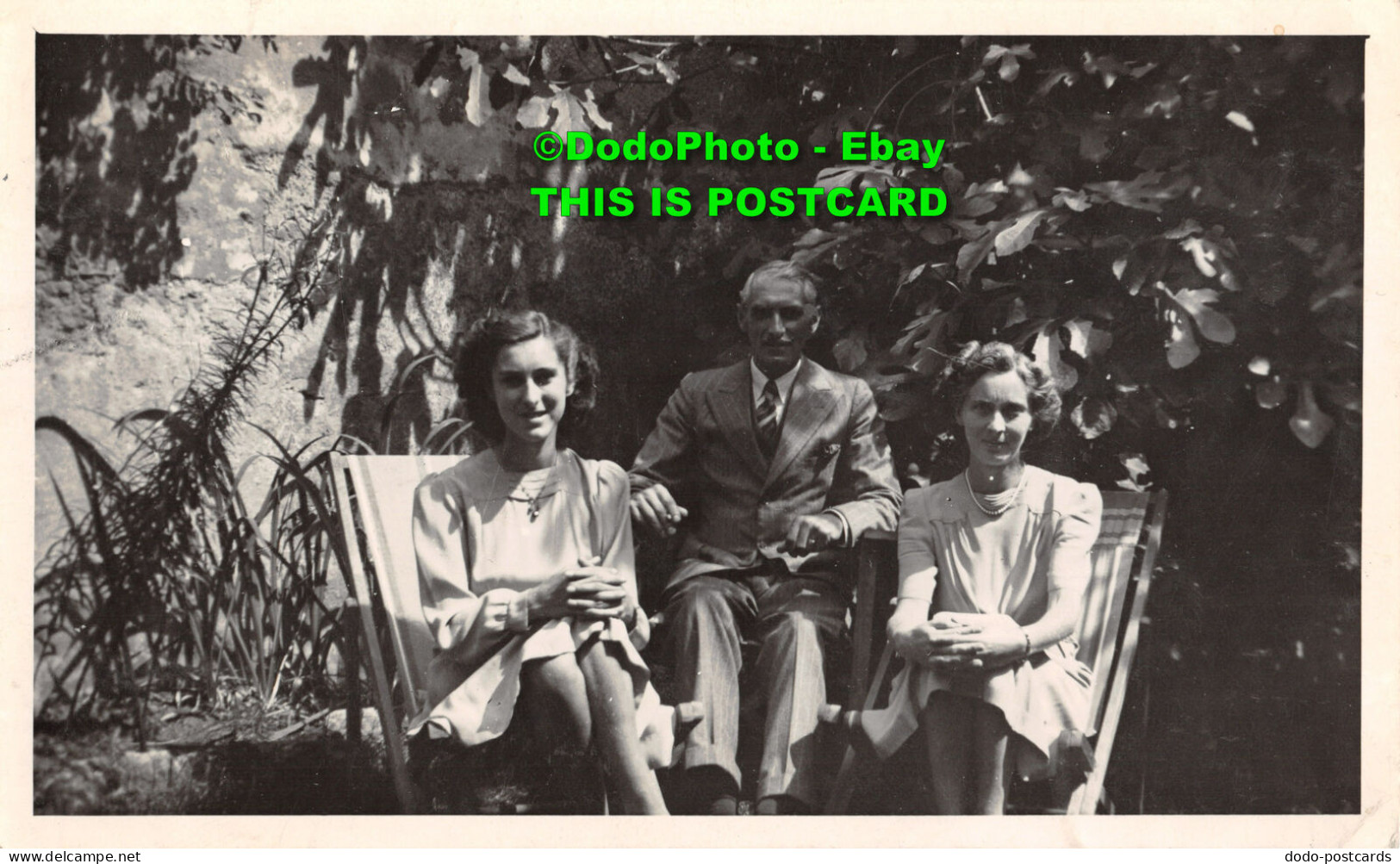 R346775 An Old Man In A Suit And Two Women Sitting On Chairs In The Garden. 1945 - World