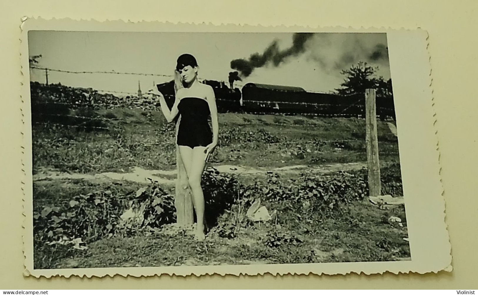 A Pretty Girl By The Fence As A Steam Locomotive Passes Behind - Personnes Anonymes